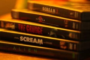 Horror movie DVDs stacked up.