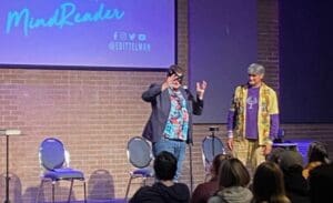 Mind reader on stage with assistant.
