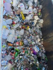 Plastic bottles and jugs in recycling bin.