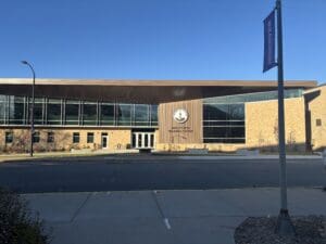 Modern wellness center building under blue sky.