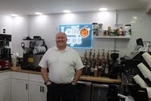 Man standing in a coffee shop kitchen.