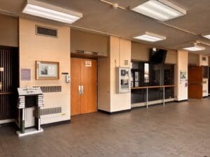 Empty hallway with closed wooden doors.