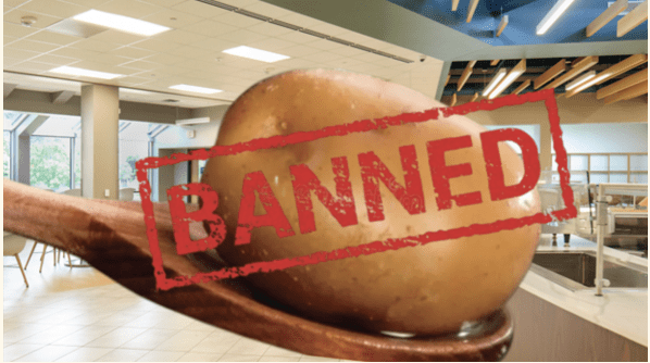 Potato on spoon labeled "Banned" in cafeteria.