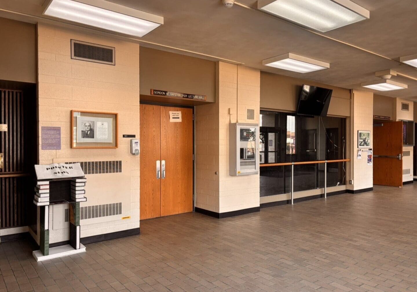 Empty hallway with closed wooden doors.